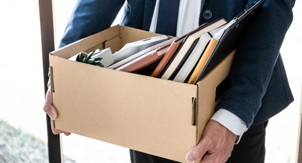 Man carrying a box of books and papers