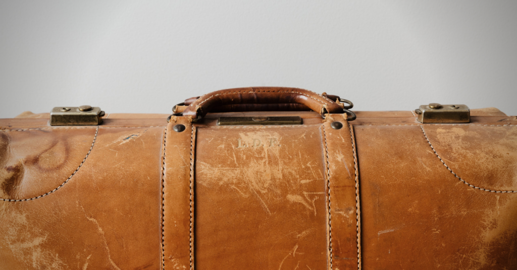 brown scuffed suitcase