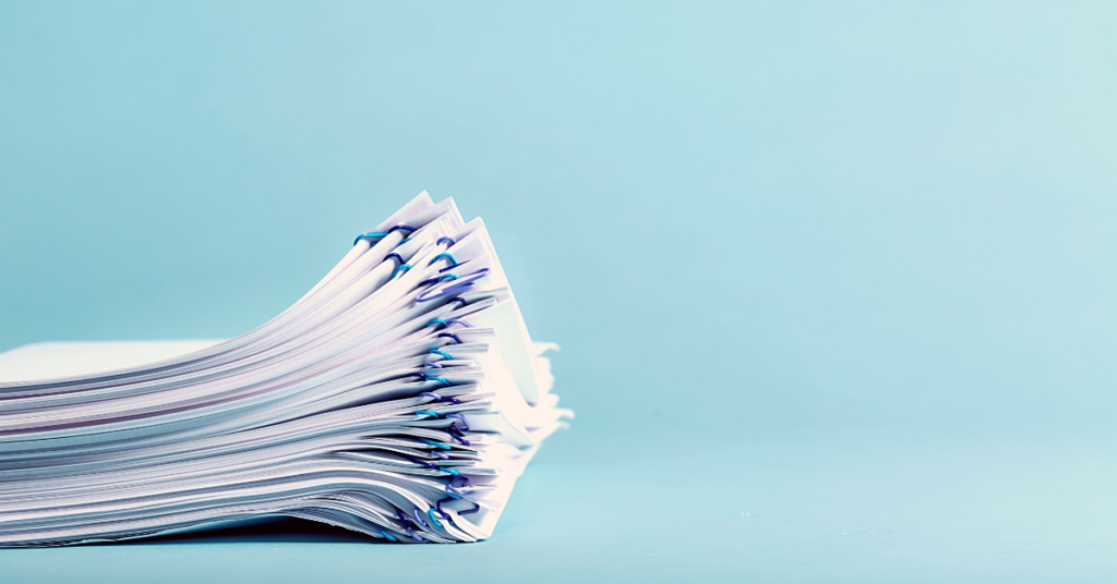 stack of papers with blue background