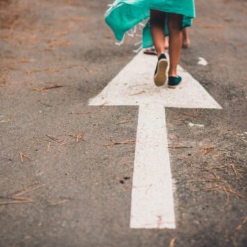 child-walking-over-sidewalk-arrow